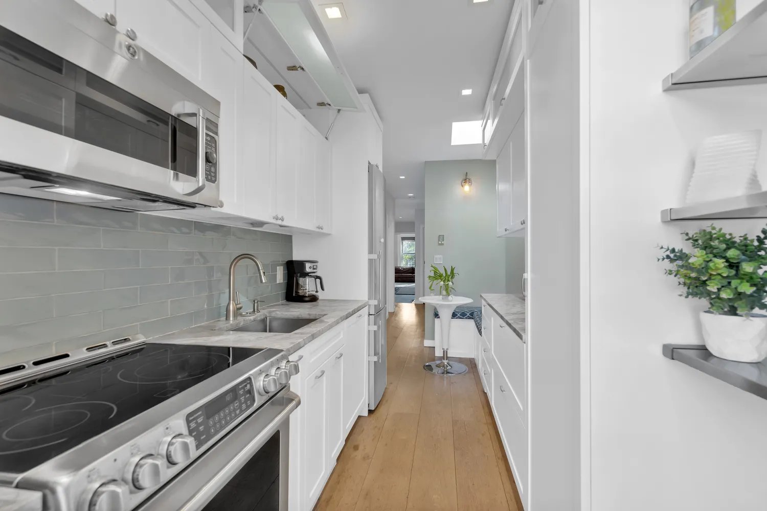 a kitchen with stainless steel appliances kitchen island a stove a sink and a refrigerator
