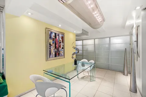 a dining room with furniture and a chandelier