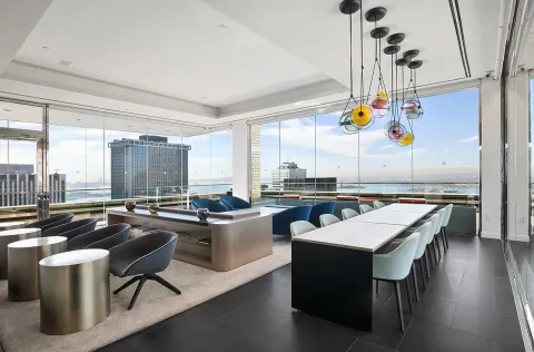 a room with wooden floor pool table and chairs