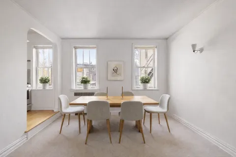 a view of a dining room with furniture and window