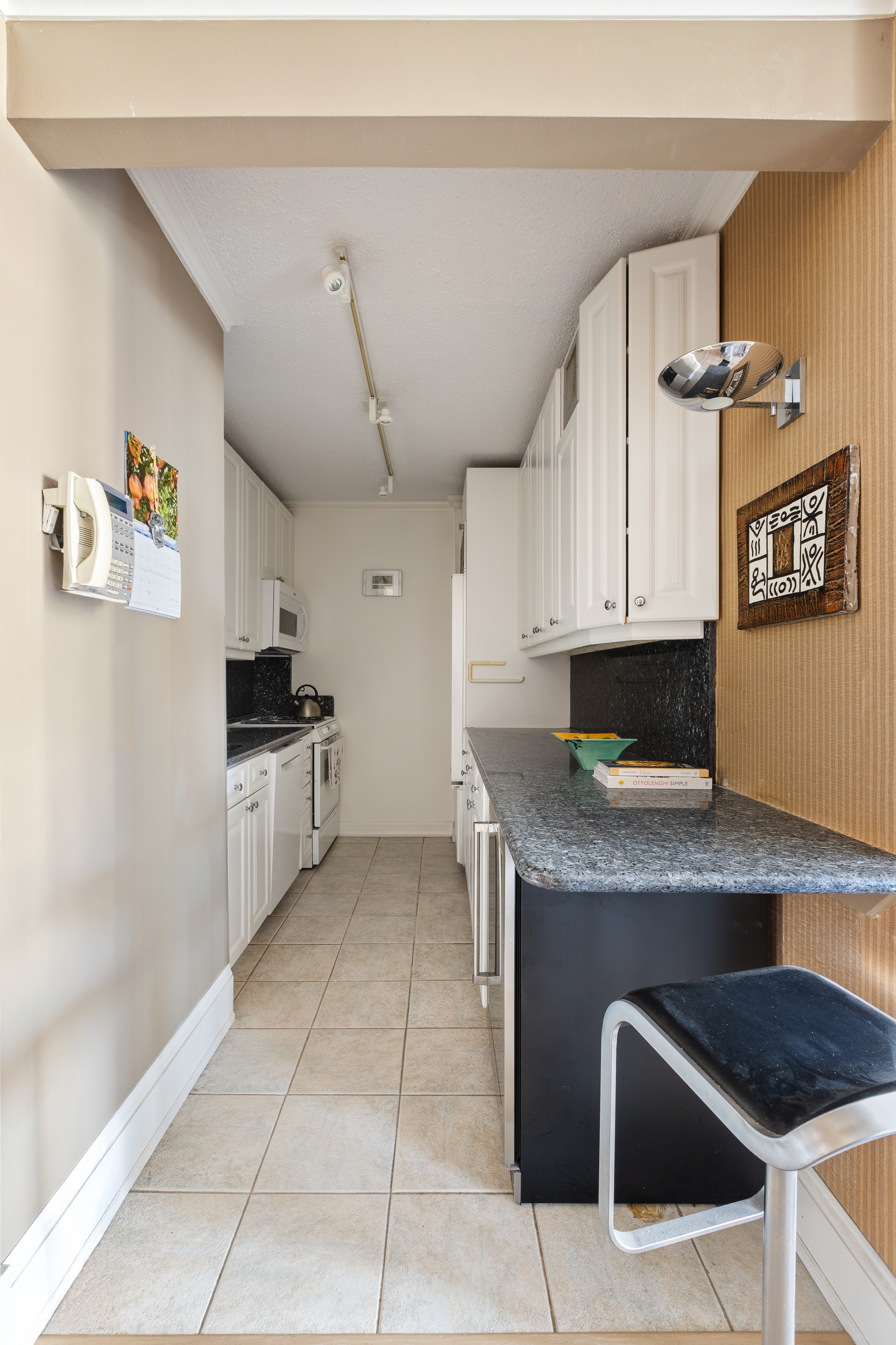 347 West 57th Street, Unit 25AB Manhattan, NY 10019 - Photo 6 of 21 a kitchen with stainless steel appliances granite countertop a sink and cabinets