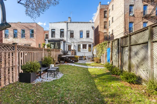 a view of a house with backyard and sitting area
