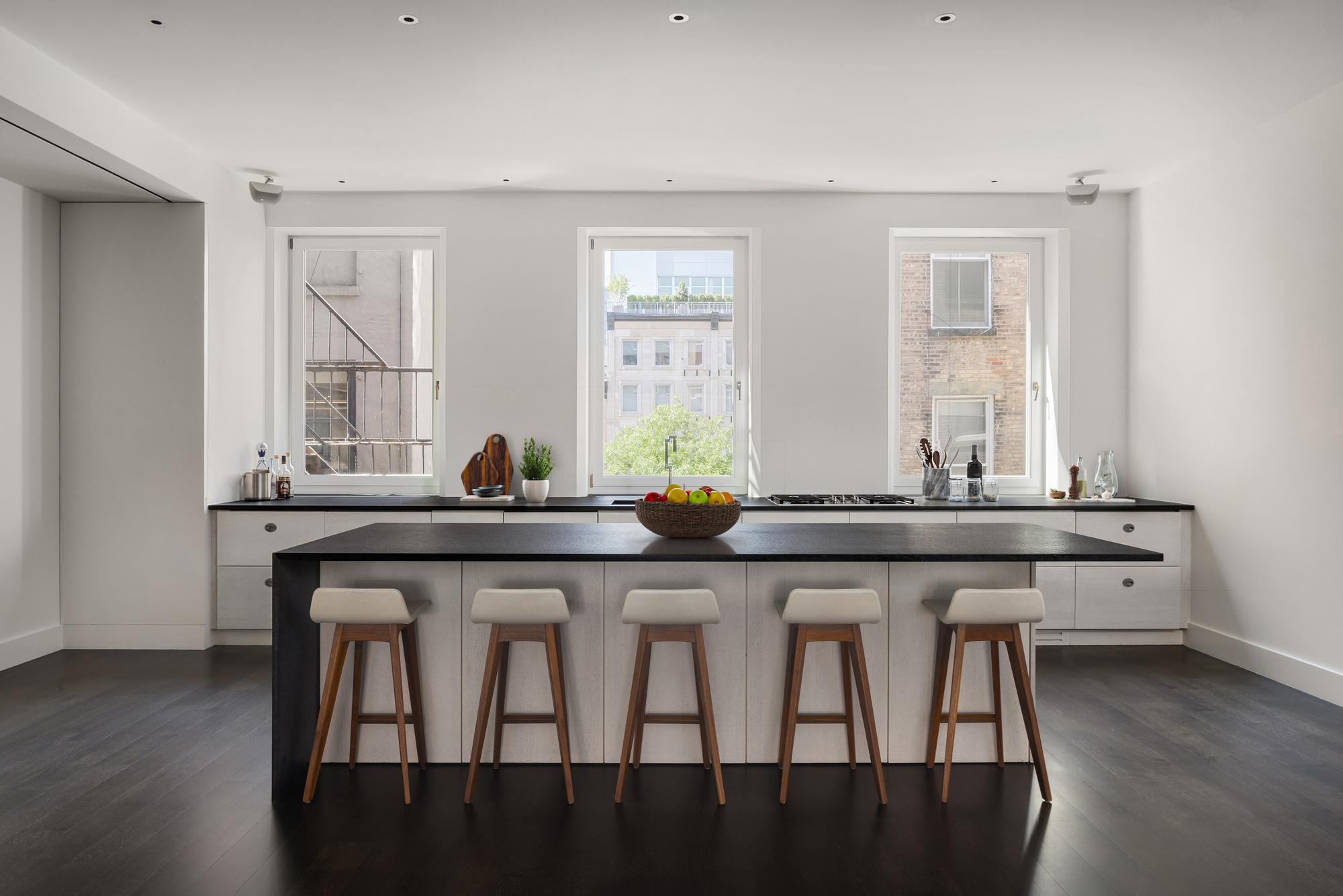 101 Wooster Street, Unit 3/4F Manhattan, NY 10012 - Photo 4 of 16 a kitchen with a sink and wooden cabinets