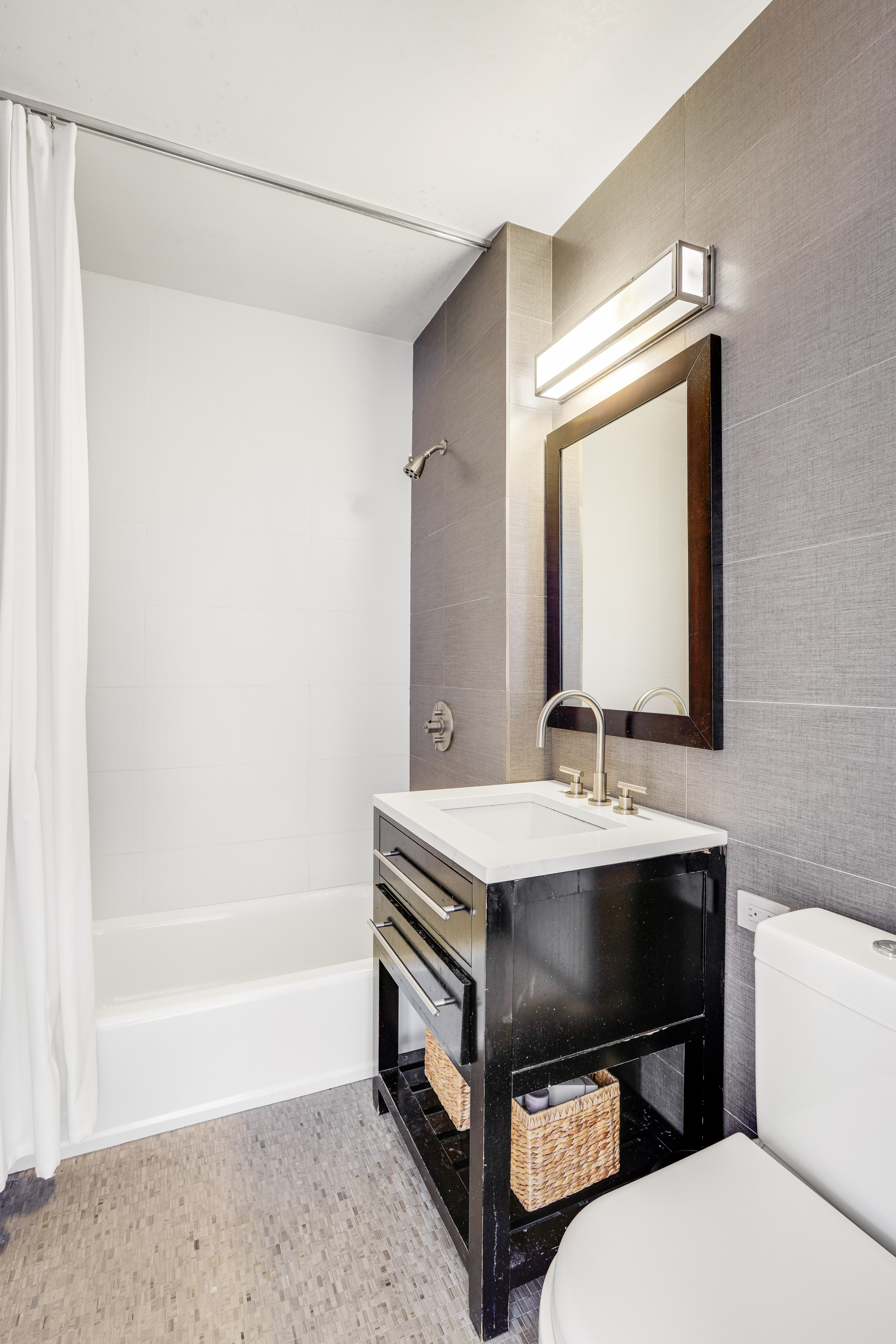 111 West 67th Street, Unit 34F Manhattan, NY 10023 - Photo 9 of 11 a bathroom with a sink a toilet and a mirror