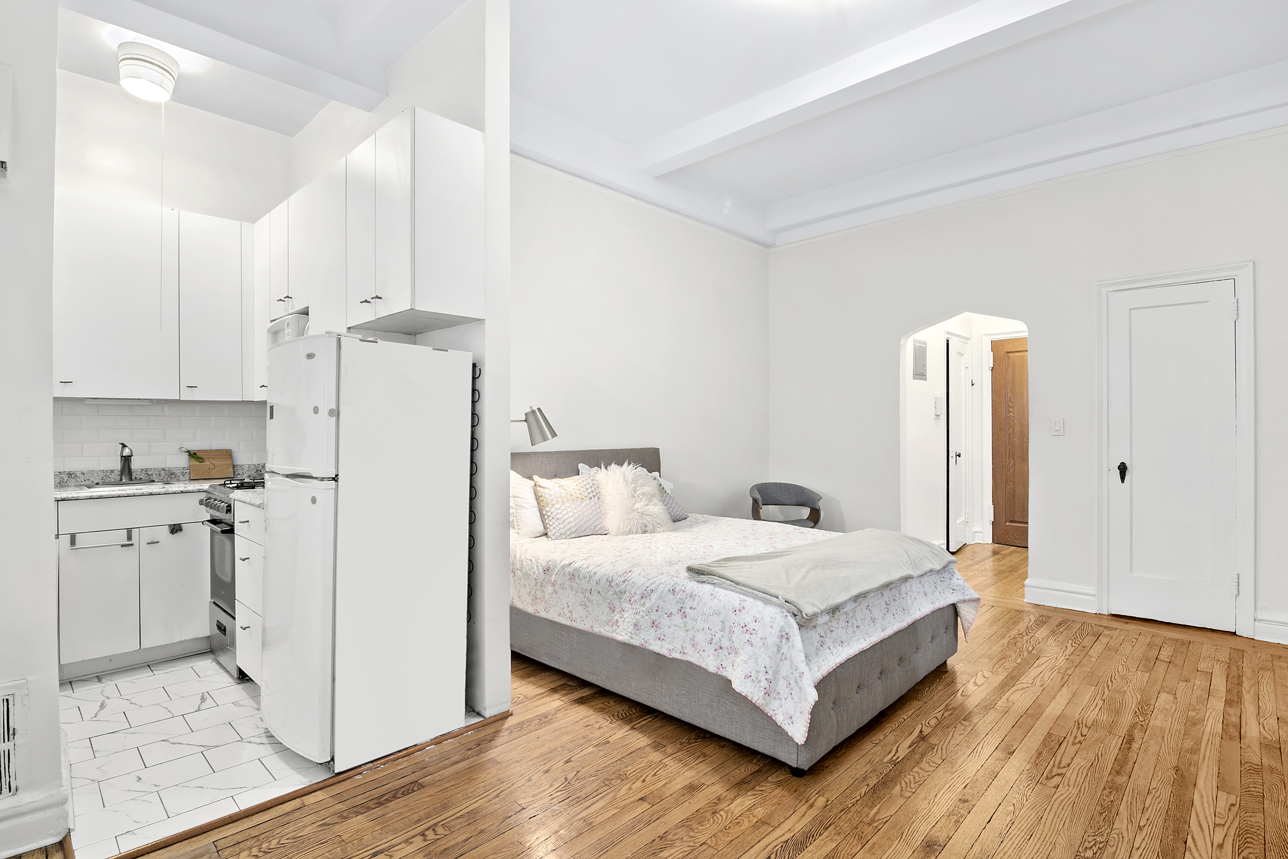 200 East 16th Street, Unit 1C Manhattan, NY 10003 - Photo 3 of 9 a room with a bed and a view of kitchen