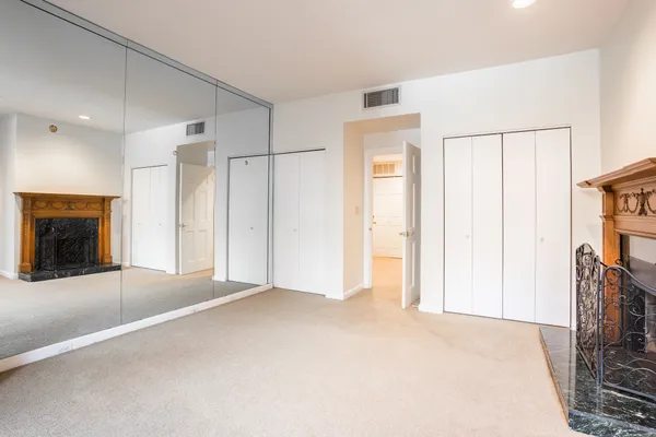 a view of empty room with fireplace and shower