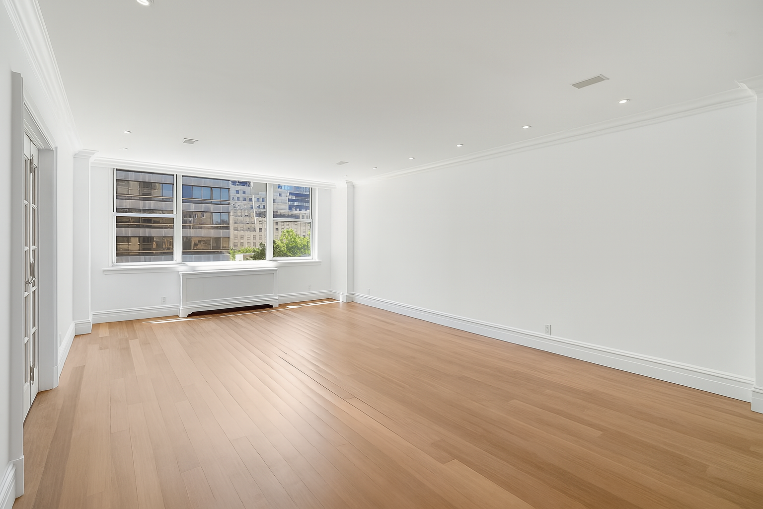 175 East 62nd Street, Unit 8D Manhattan, NY 10065 - Photo 8 of 24 an empty room with wooden floor and windows