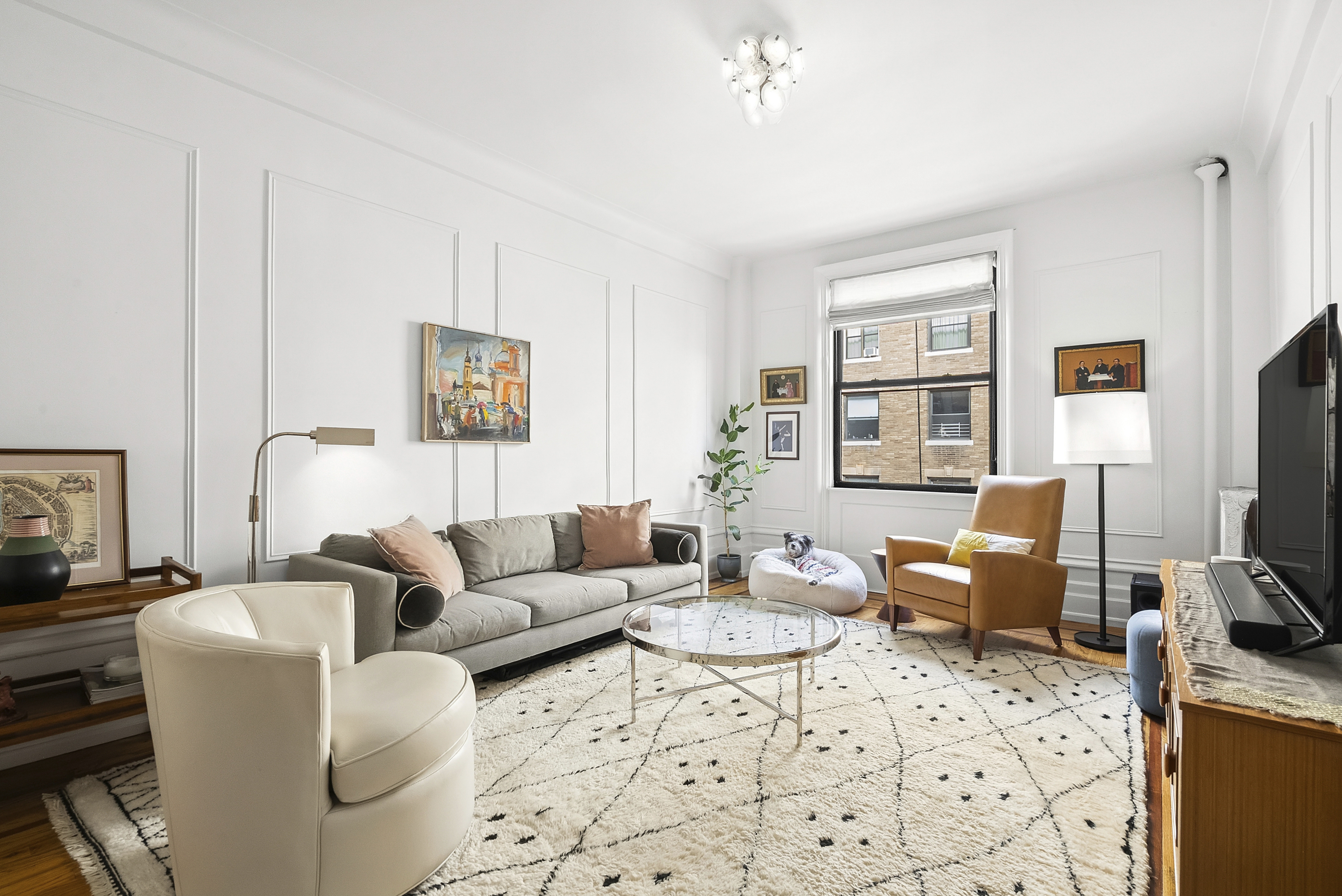536 West 111th Street, Unit 66 Manhattan, NY 10025 - Photo 1 of 8 a living room with furniture a flat screen tv and a window