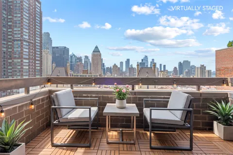 a view of roof deck with seating space and plants