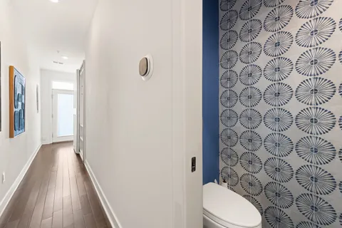 a bathroom with a toilet and a shower curtain