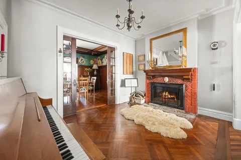 a view of a livingroom with wooden floor and a fireplace