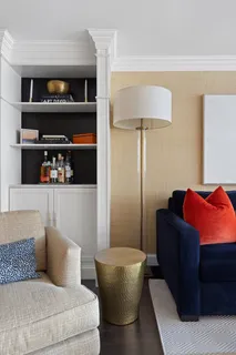 a living room with furniture and a lamp