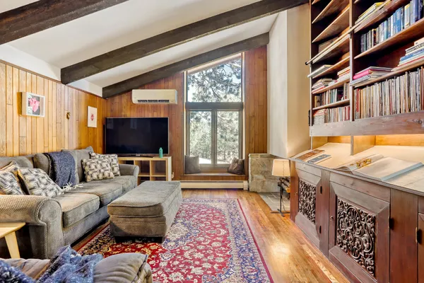 a kitchen with a sink and wooden floor