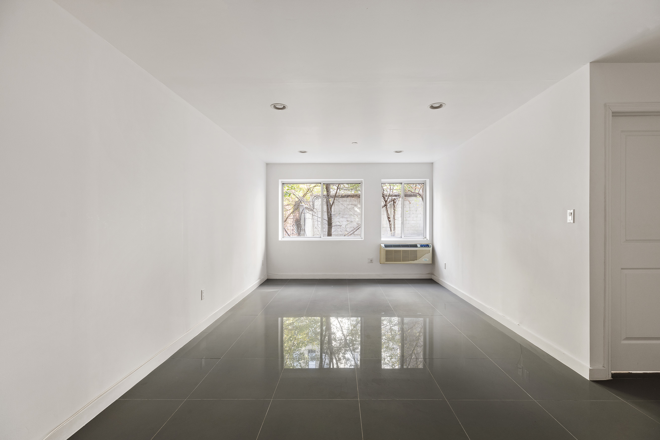 371 West 126th Street, Unit 2N Manhattan, NY 10027 - Photo 2 of 6 an empty room with windows