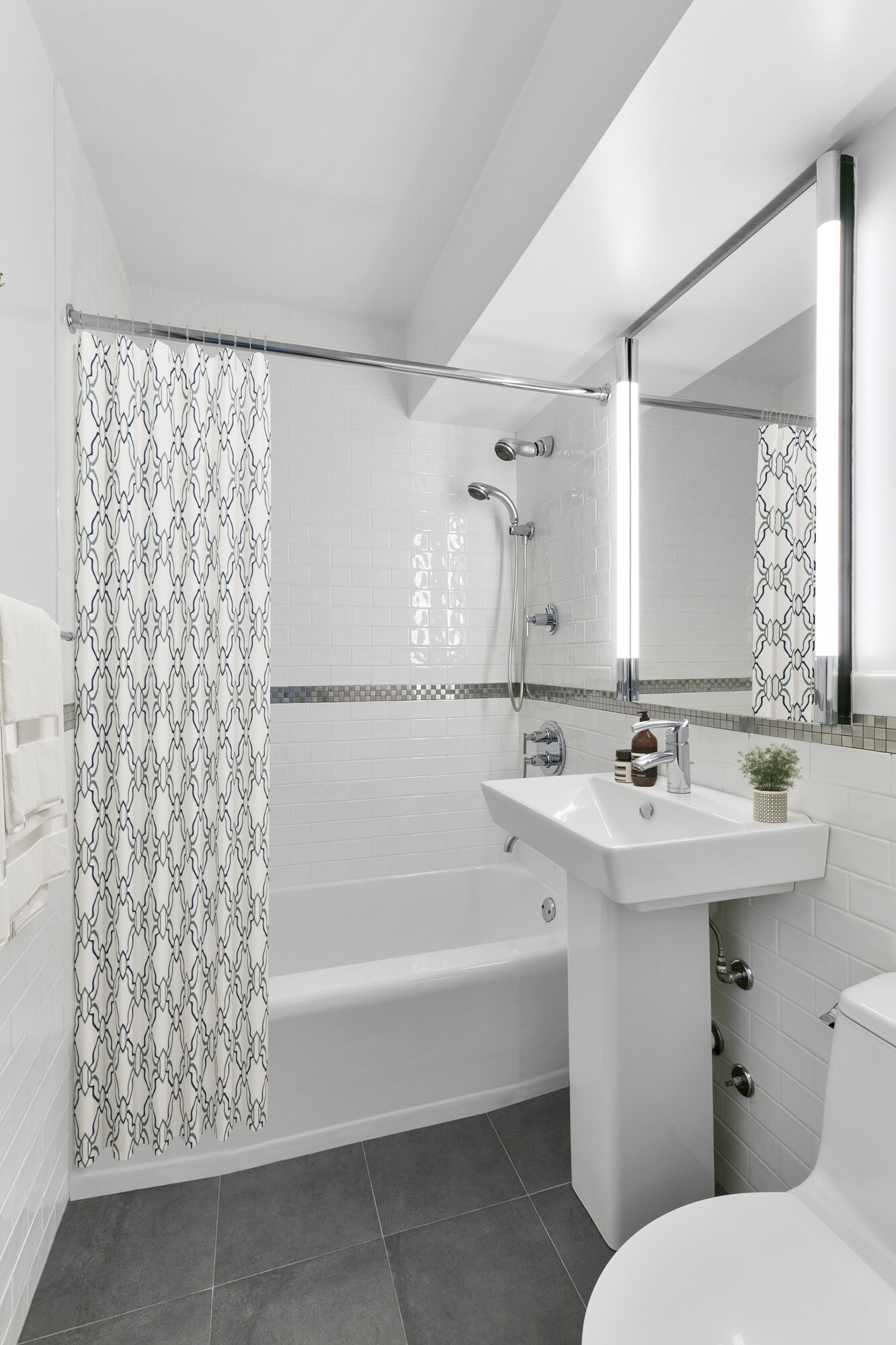 411 East 53rd Street, Unit 19D Manhattan, NY 10022 - Photo 11 of 13 a bathroom with a sink a toilet and shower