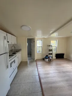 a view of a kitchen with microwave and furniture