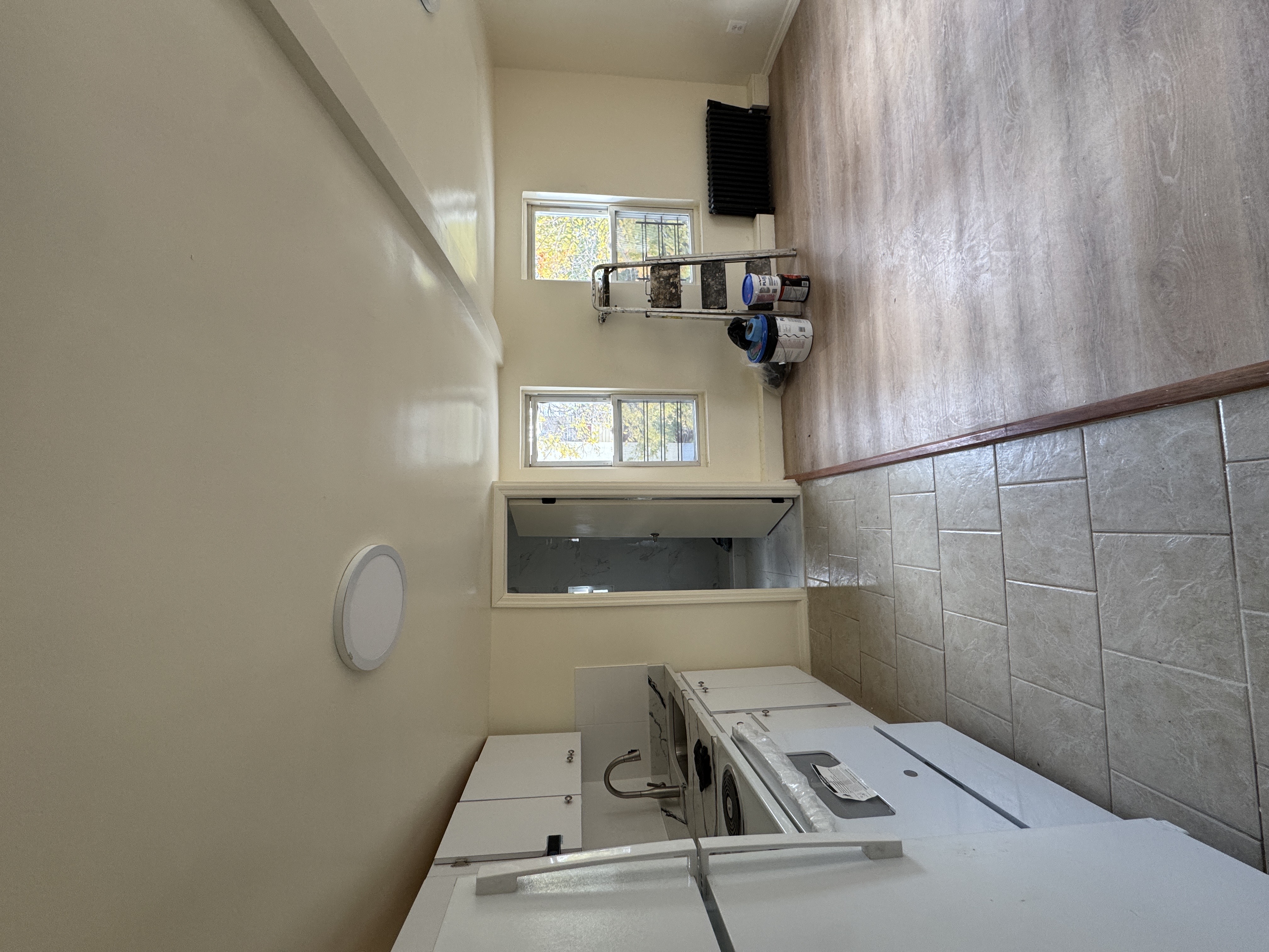 1333 Bristow Street Bronx, NY 10459 - Photo 5 of 6 a view of a kitchen with microwave and furniture