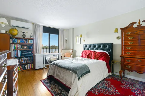 a bed room with a bed and a book shelf