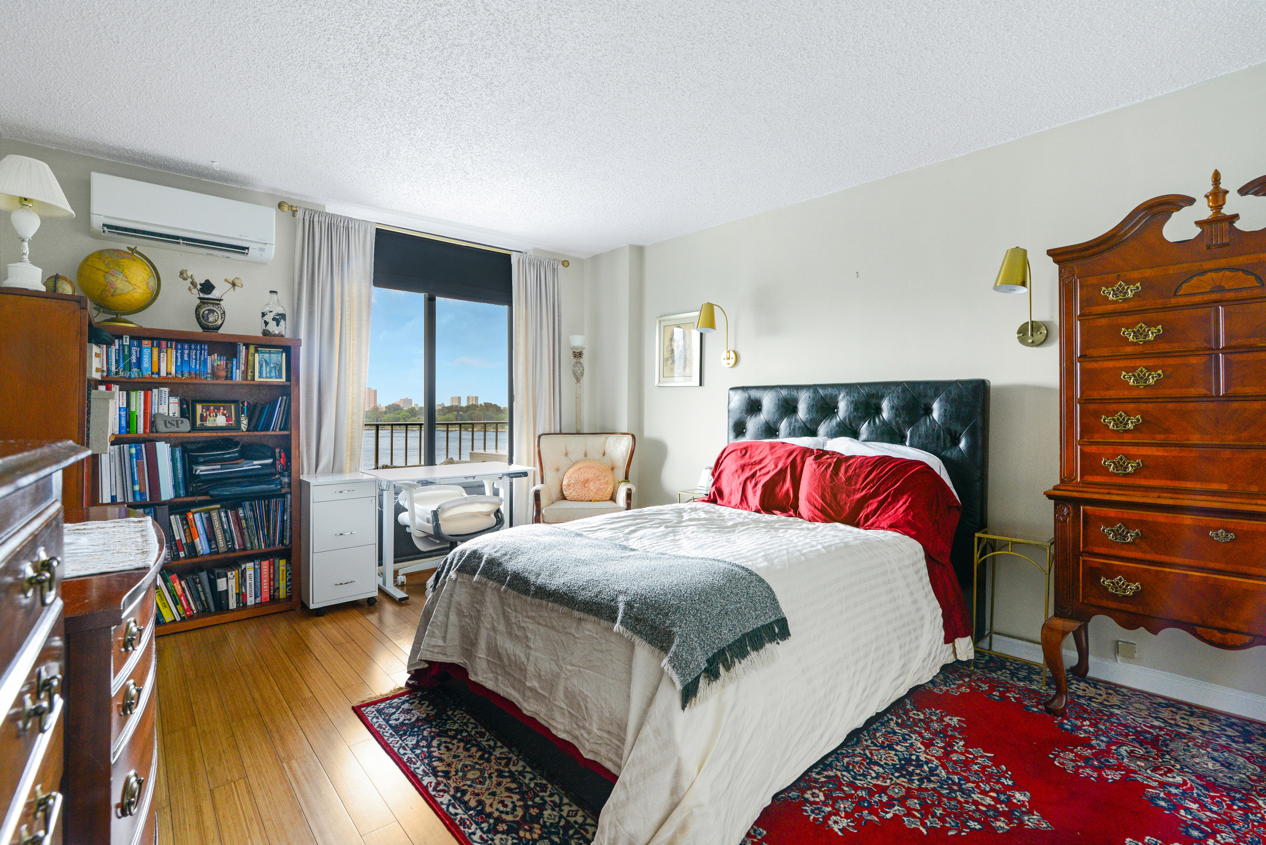 2540 Shore Boulevard, Unit 4S Queens, NY 11102 - Photo 7 of 21 a bed room with a bed and a book shelf