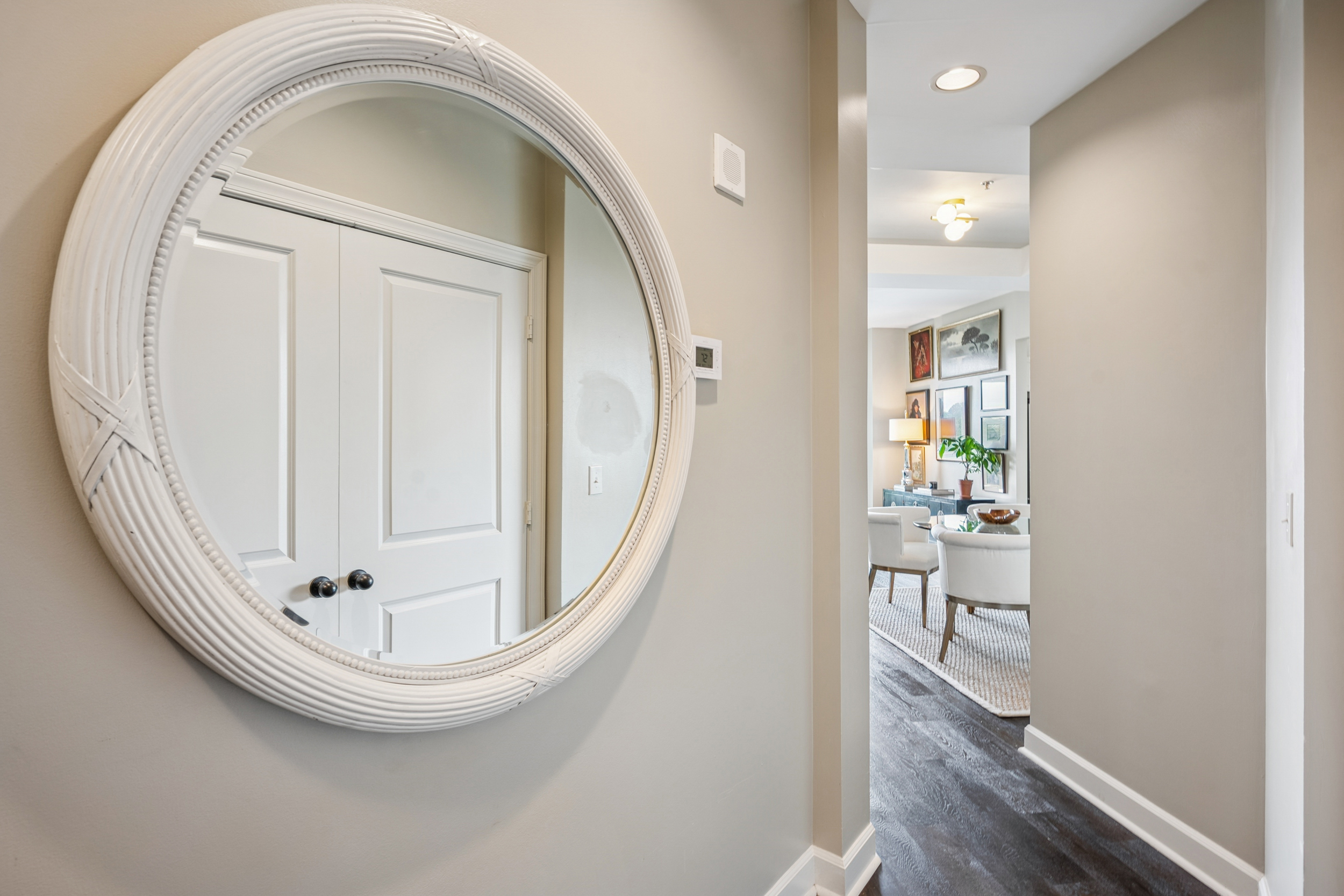 2626 Peachtree Road, Unit 1108 Atlanta, GA 30305 - Photo 2 of 25 an empty room with wooden floor mirror and windows