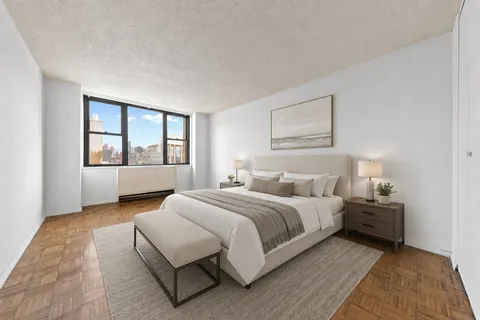 a bedroom with a large bed and a window