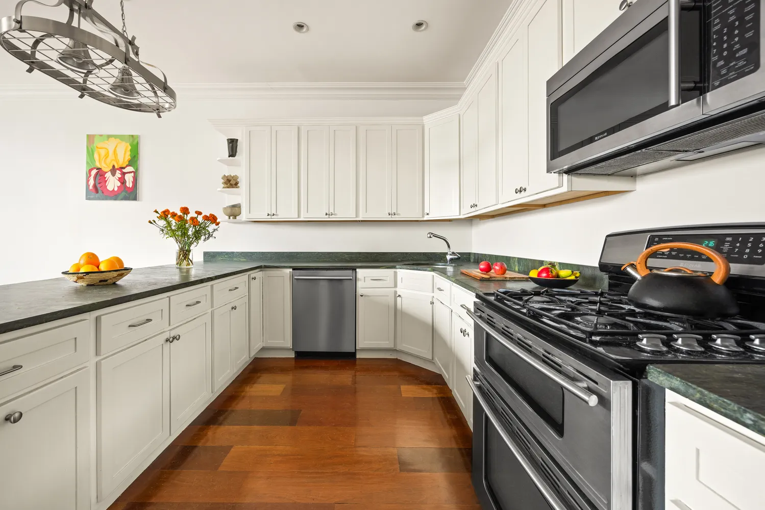 a kitchen with stainless steel appliances granite countertop a stove and a sink