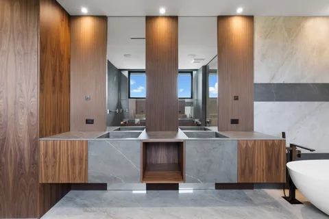 a living room with couches and painted walls with wooden floor