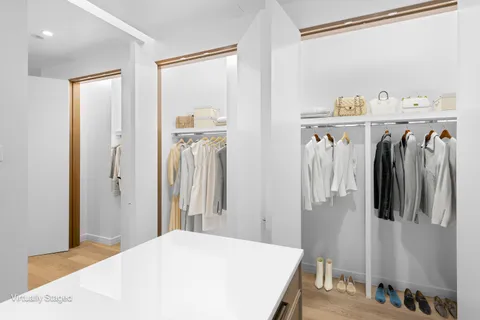 a bedroom with a bed and a refrigerator