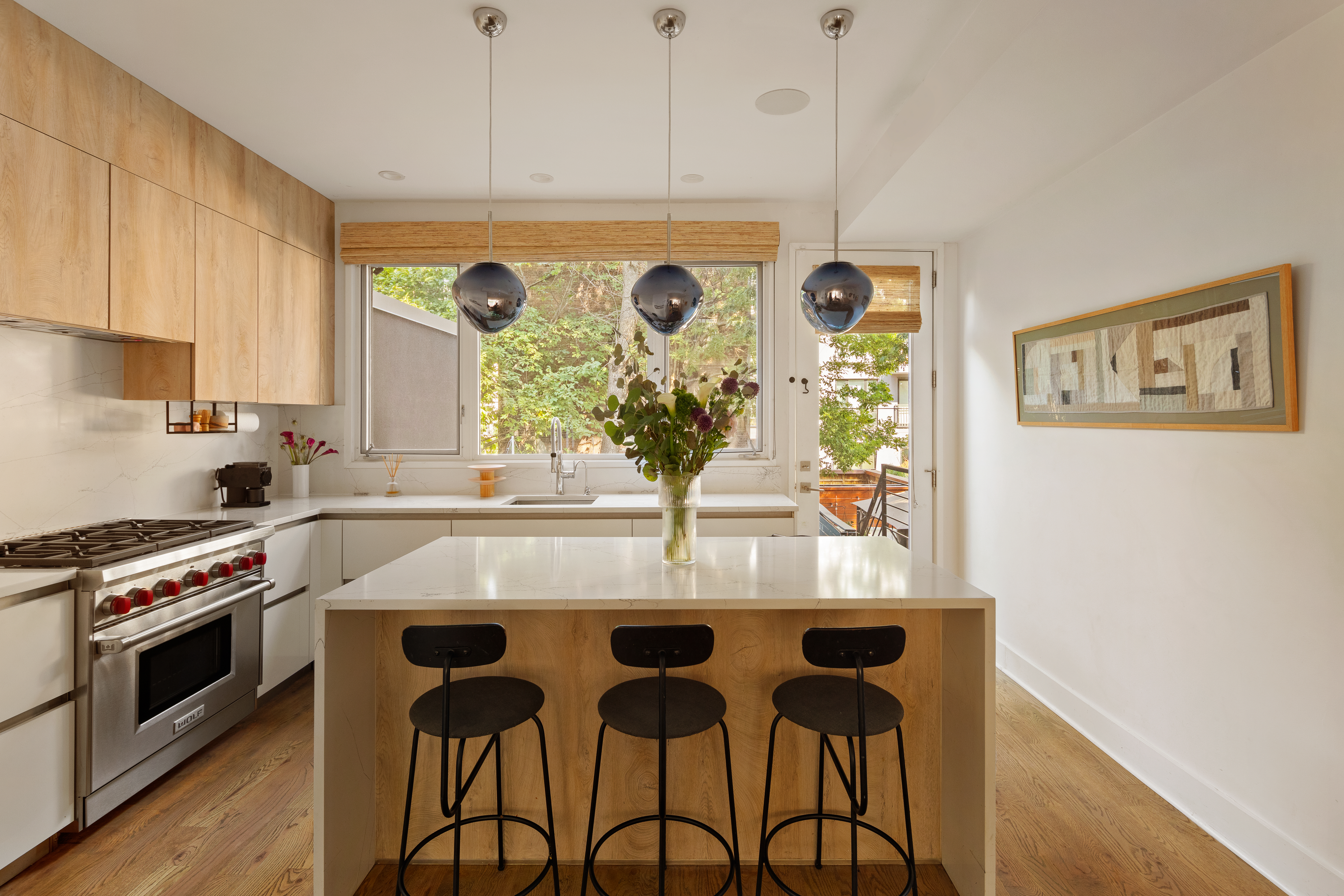 197 Madison Street Brooklyn, NY 11216 - Photo 5 of 19 a kitchen with stainless steel appliances granite countertop a stove a refrigerator white cabinets and wooden floor