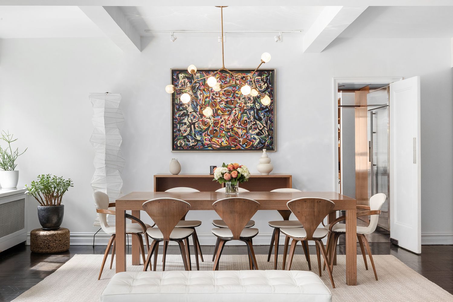 a view of a dining room with furniture and a chandelier
