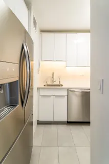 a utility room with cabinets washer and dryer