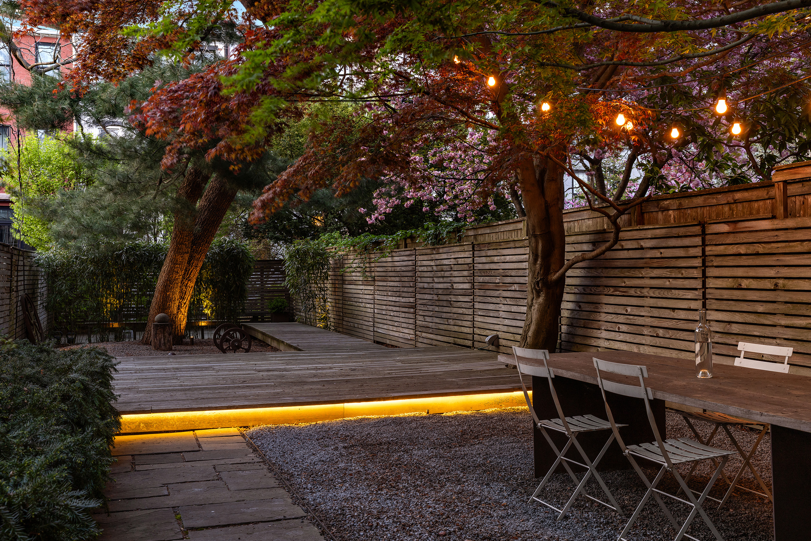 177 Prospect Place Brooklyn, NY 11238 - Photo 38 of 42 a view of a backyard with chairs and table under an umbrella
