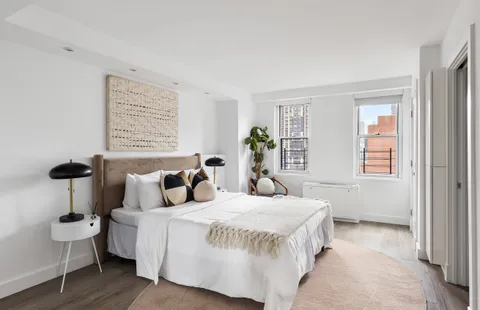 a bedroom with a bed and a table