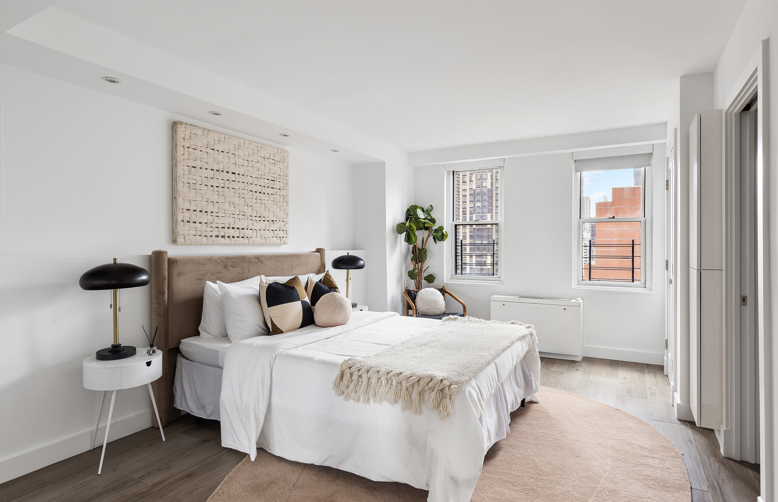 340 East 64th Street, Unit 19L Manhattan, NY 10065 - Photo 12 of 17 a bedroom with a bed and a table