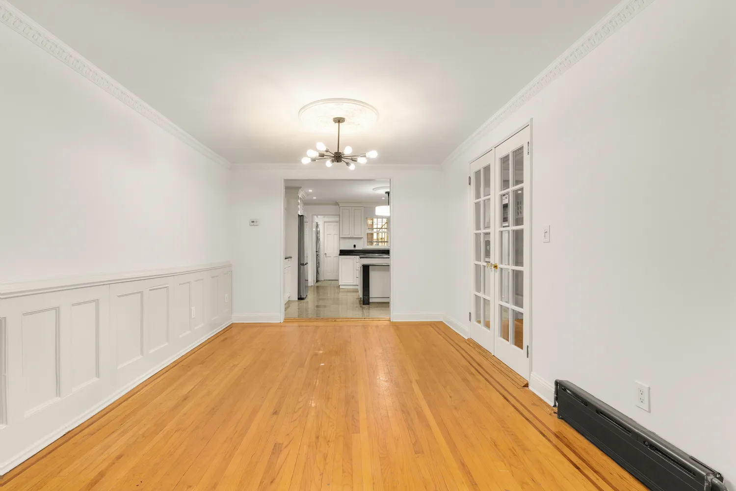 a view of a room with wooden floor and staircase