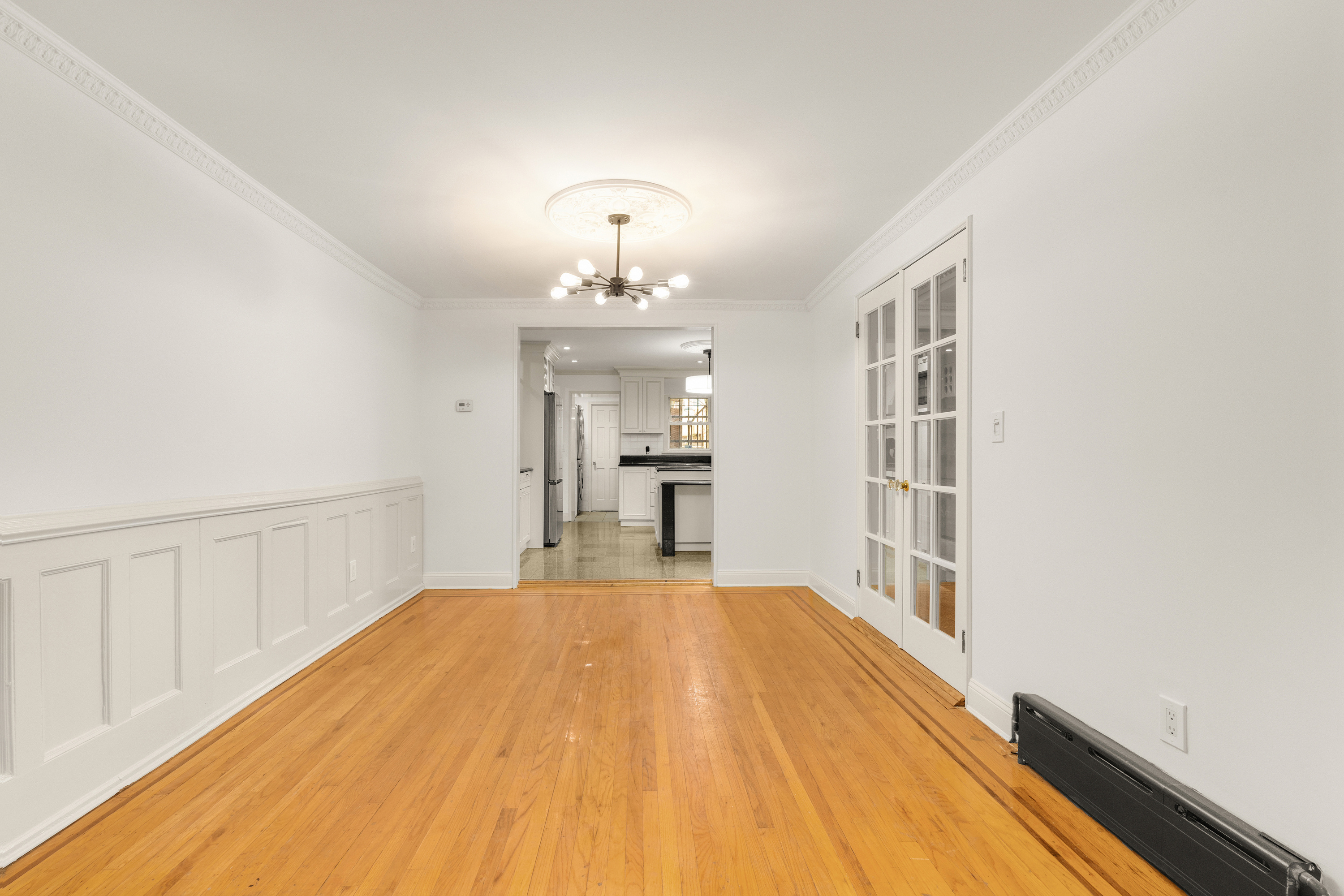 688 Saint Marks Avenue, Unit GARDEN Brooklyn, NY 11216 - Photo 4 of 13 a view of a room with wooden floor and staircase