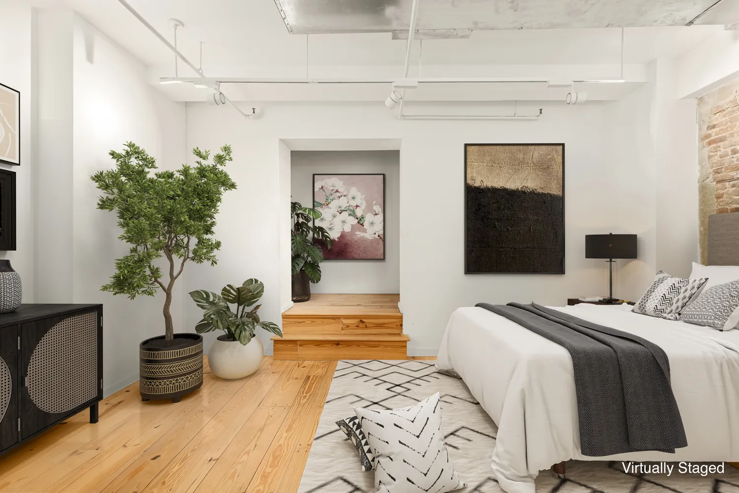 a bedroom with a bed and a potted plant