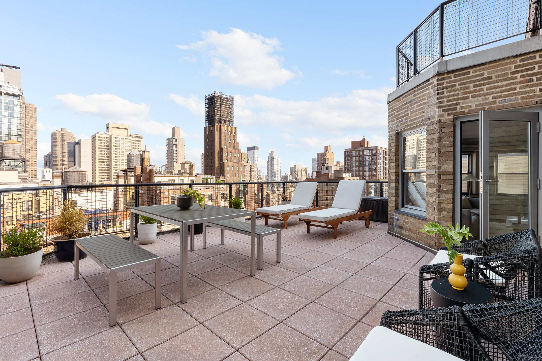 80 Park Avenue, Unit 19N Manhattan, NY 10016 - Photo 2 of 20 a view of a terrace with chairs and a potted plant