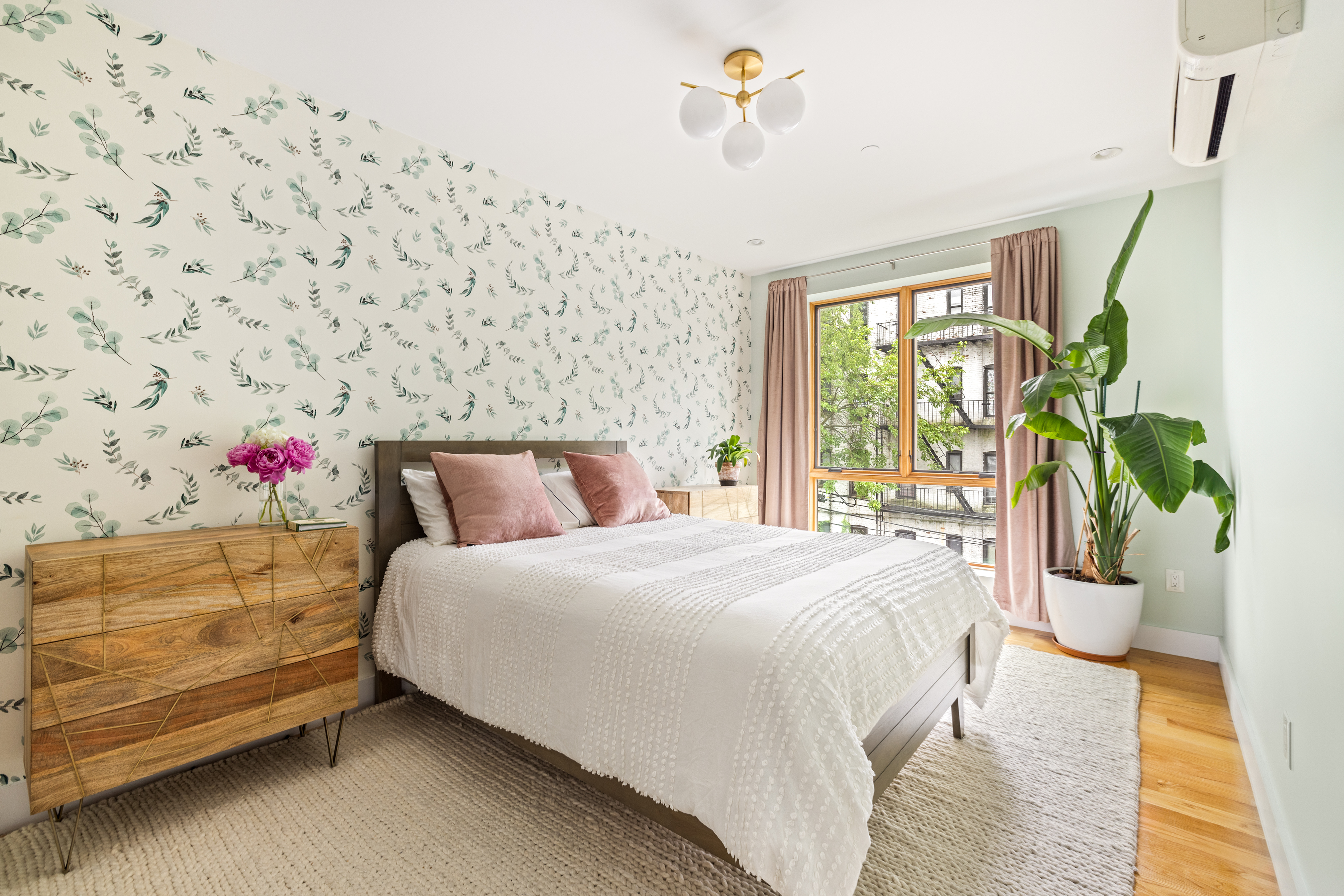 1204 Saint Marks Avenue, Unit 4R Brooklyn, NY 11213 - Photo 7 of 14 a bedroom with a bed and a potted plant