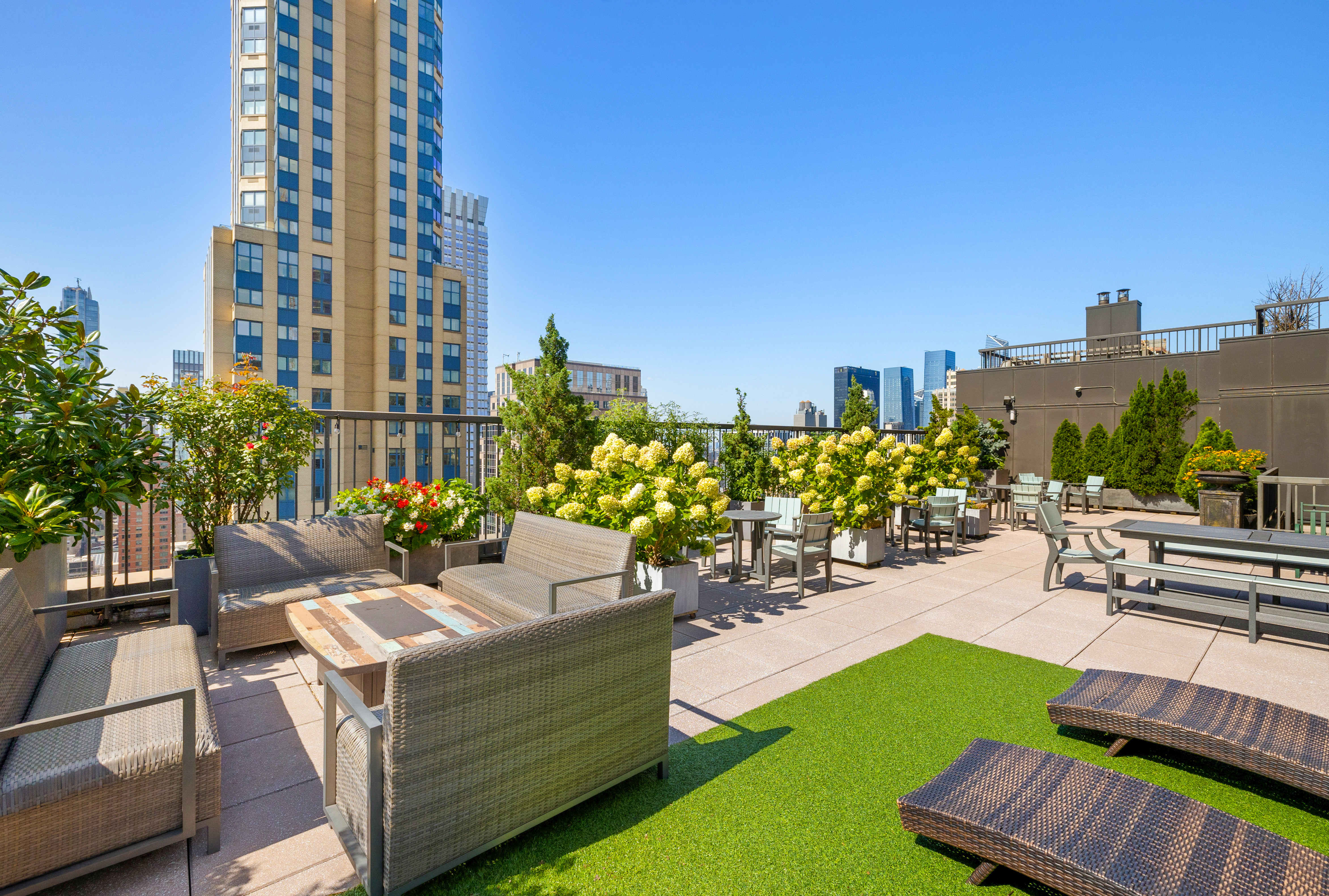 445 5th Avenue, Unit 26F Manhattan, NY 10016 - Photo 9 of 11 a view of a patio with couches and table and chairs and potted plants