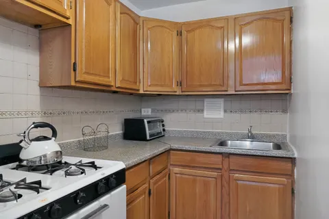 a kitchen with granite countertop cabinets a sink and dishwasher