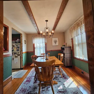 a dining room with furniture and window
