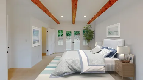a bedroom with a bed and a potted plant