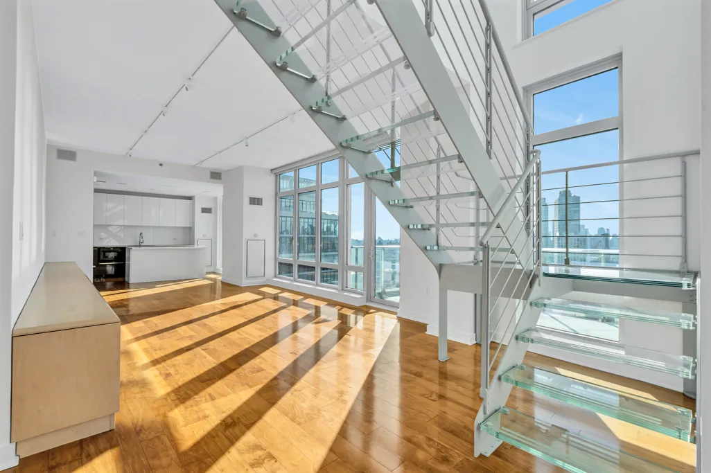 a bedroom with a bed and a large window with outer view