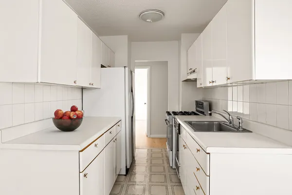 a kitchen that has a sink and a stove