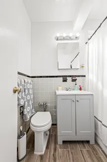 a bathroom with a sink toilet and a mirror