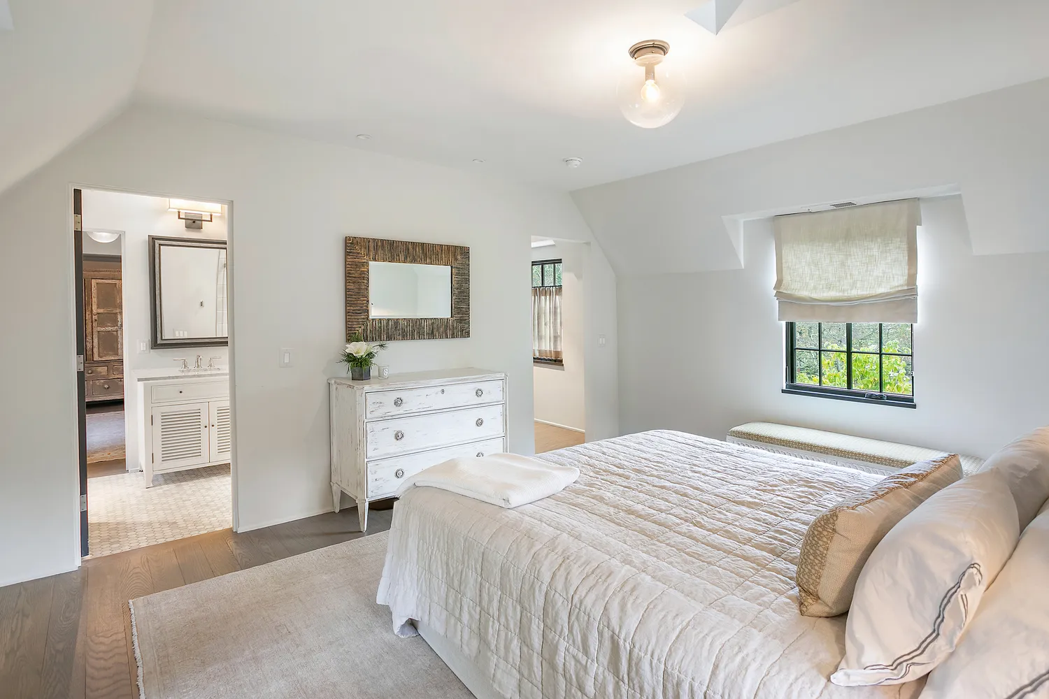a bedroom with a bed and a view of kitchen