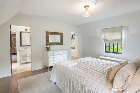 a bedroom with a bed and a view of kitchen