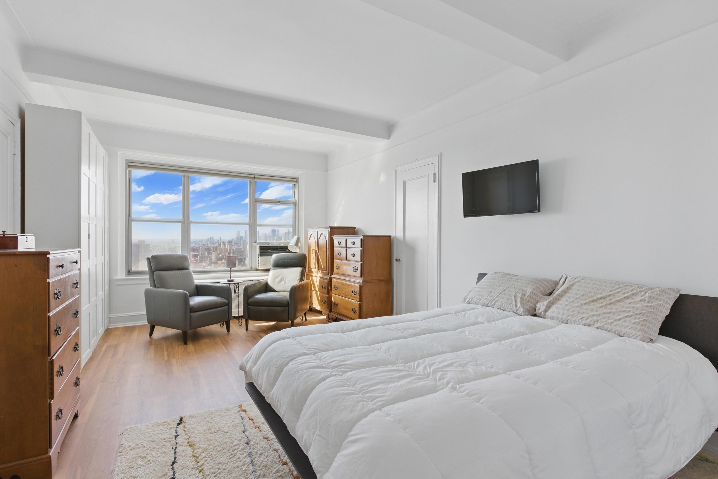 1 Plaza Street West, Unit 12C Brooklyn, NY 11217 - Photo 7 of 13 a bedroom with a bed and a flat screen tv