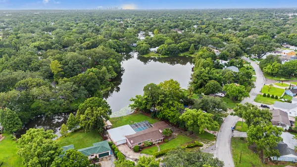 an aerial view of a house with a yard